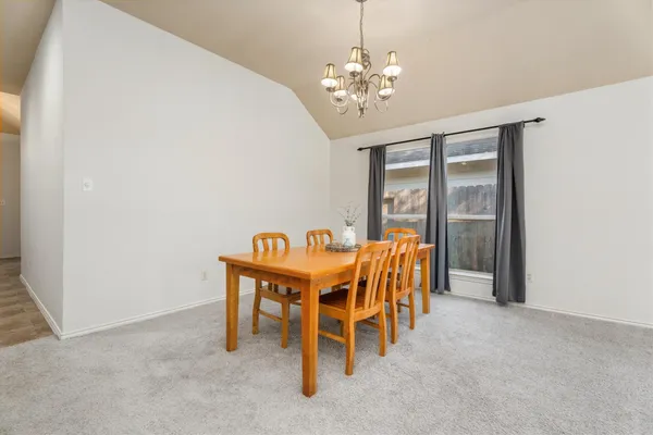 a dining room with furniture and chandelier
