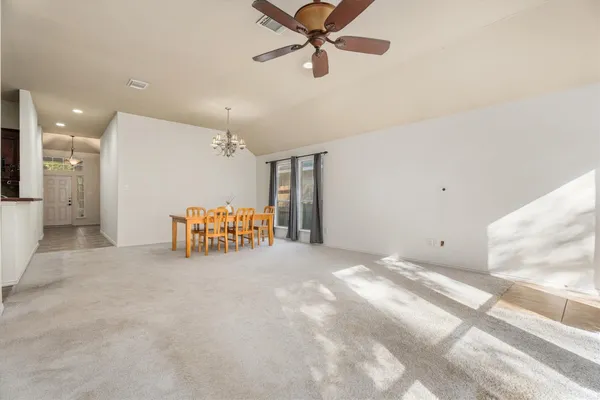 a dining room with furniture chandelier and a window