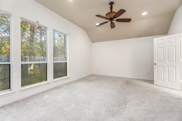 a view of a livingroom with a ceiling fan and window