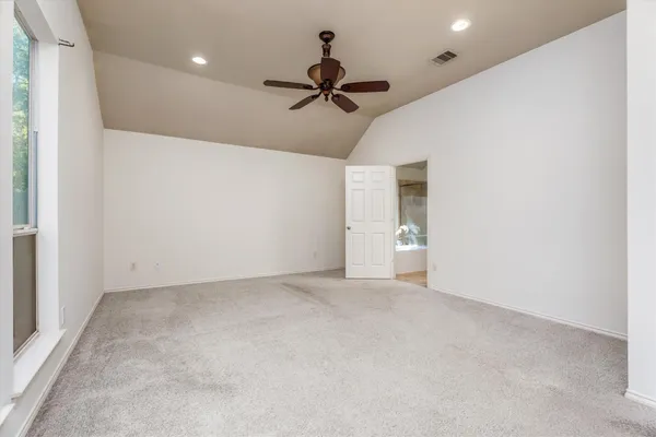 an empty room with fan and a ceiling fan