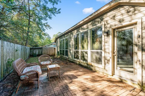 a backyard of a house with fountain table and chairs