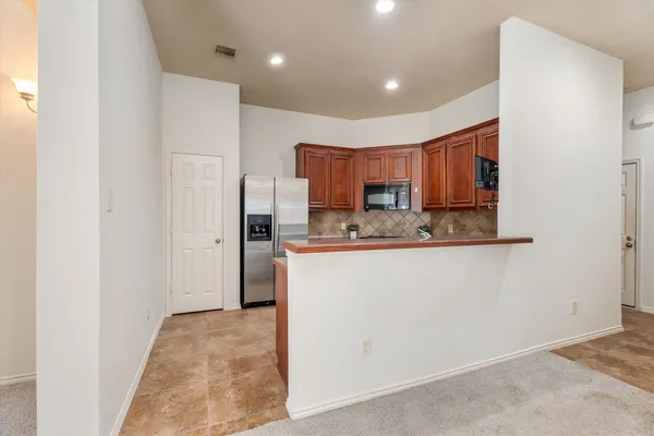 a kitchen with stainless steel appliances granite countertop a stove microwave and sink