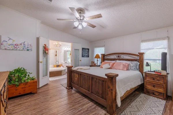 a bedroom with a bed and a chandelier
