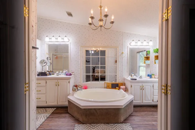 a bedroom with a bed and a chandelier