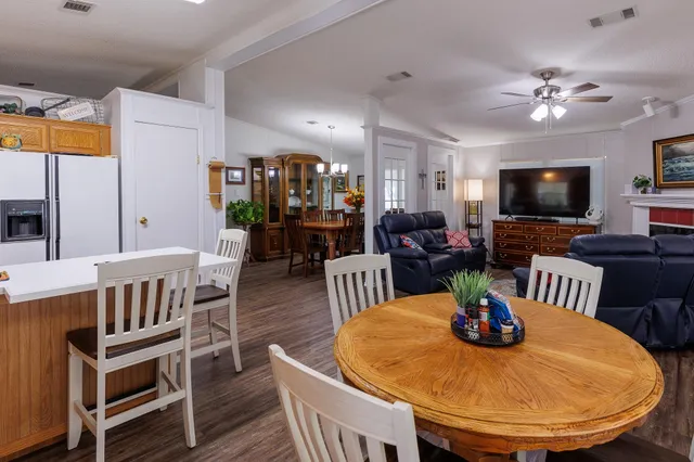 a kitchen with a sink a stove and a wooden floor