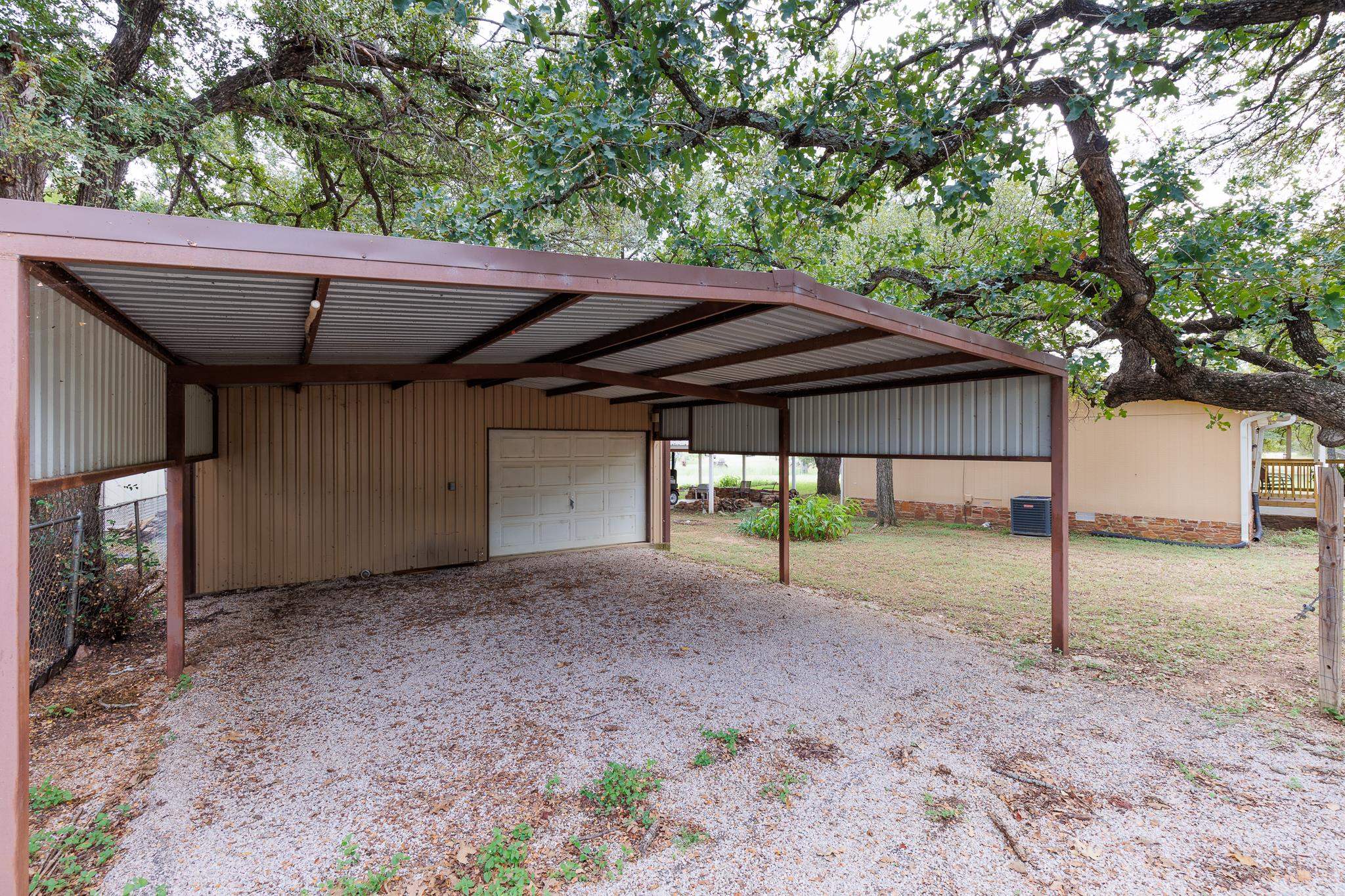 200 Munson Tow, TX 78672 - Photo 26 of 29 a backyard of a house with table and chairs under an umbrella