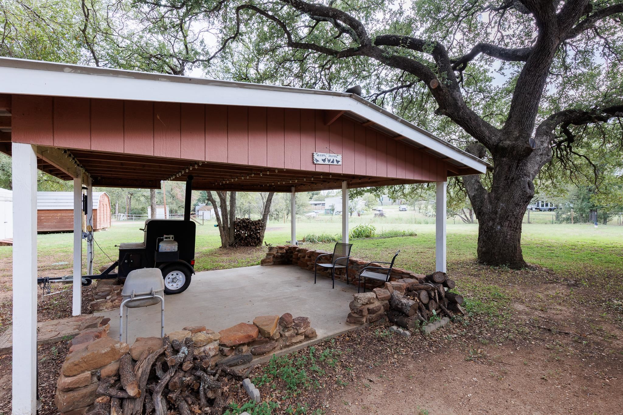 200 Munson Tow, TX 78672 - Photo 27 of 29 a backyard of a house with barbeque oven table and chairs