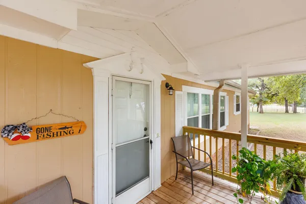 a view of a porch with furniture and garden