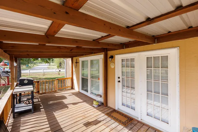 an outdoor view of house with backyard and deck