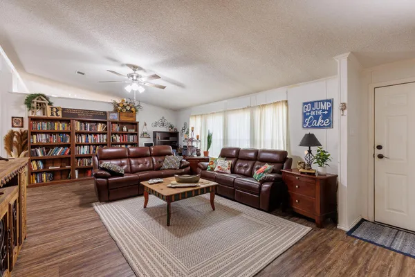 a living room with furniture and wooden floor