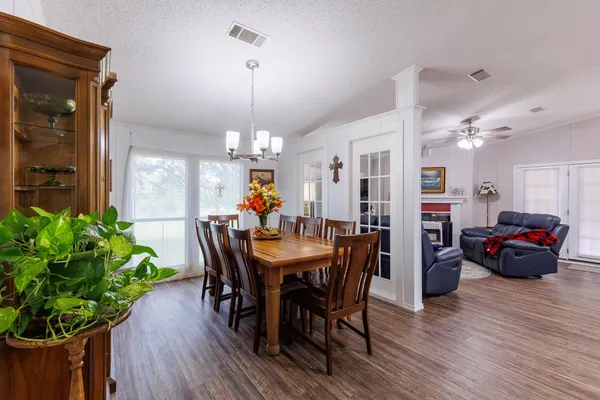 a view of a dining room with furniture and wooden floor