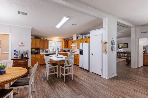 a dining room with furniture and wooden floor
