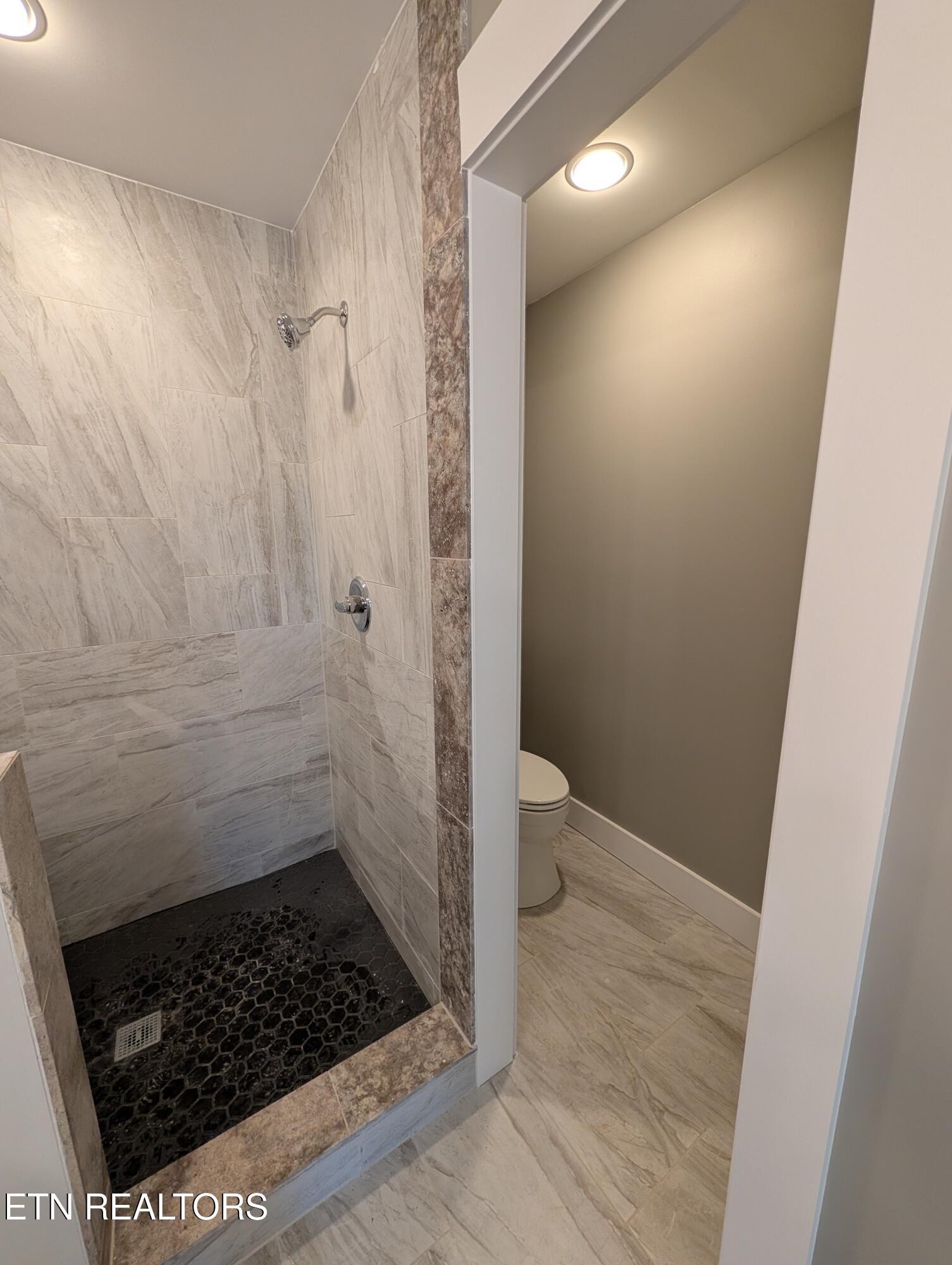 144 Abbott Road Lenoir City, TN 37771 - Photo 13 of 24 a bathroom with a sink a toilet and shower