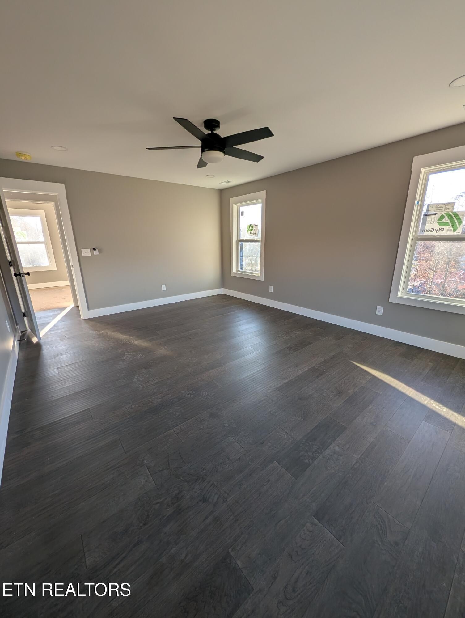 144 Abbott Road Lenoir City, TN 37771 - Photo 14 of 24 an empty room with wooden floor fan and windows