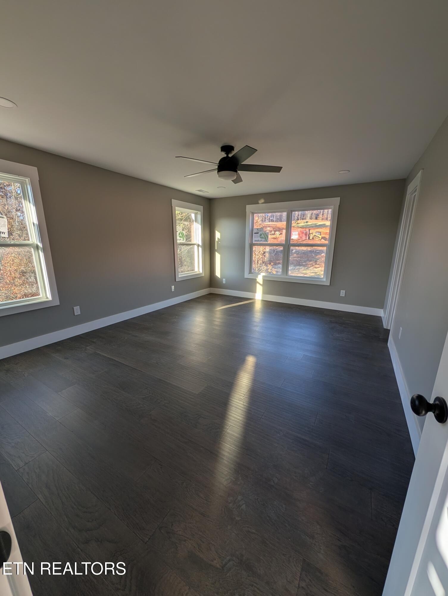 144 Abbott Road Lenoir City, TN 37771 - Photo 15 of 24 an empty room with wooden floor and windows