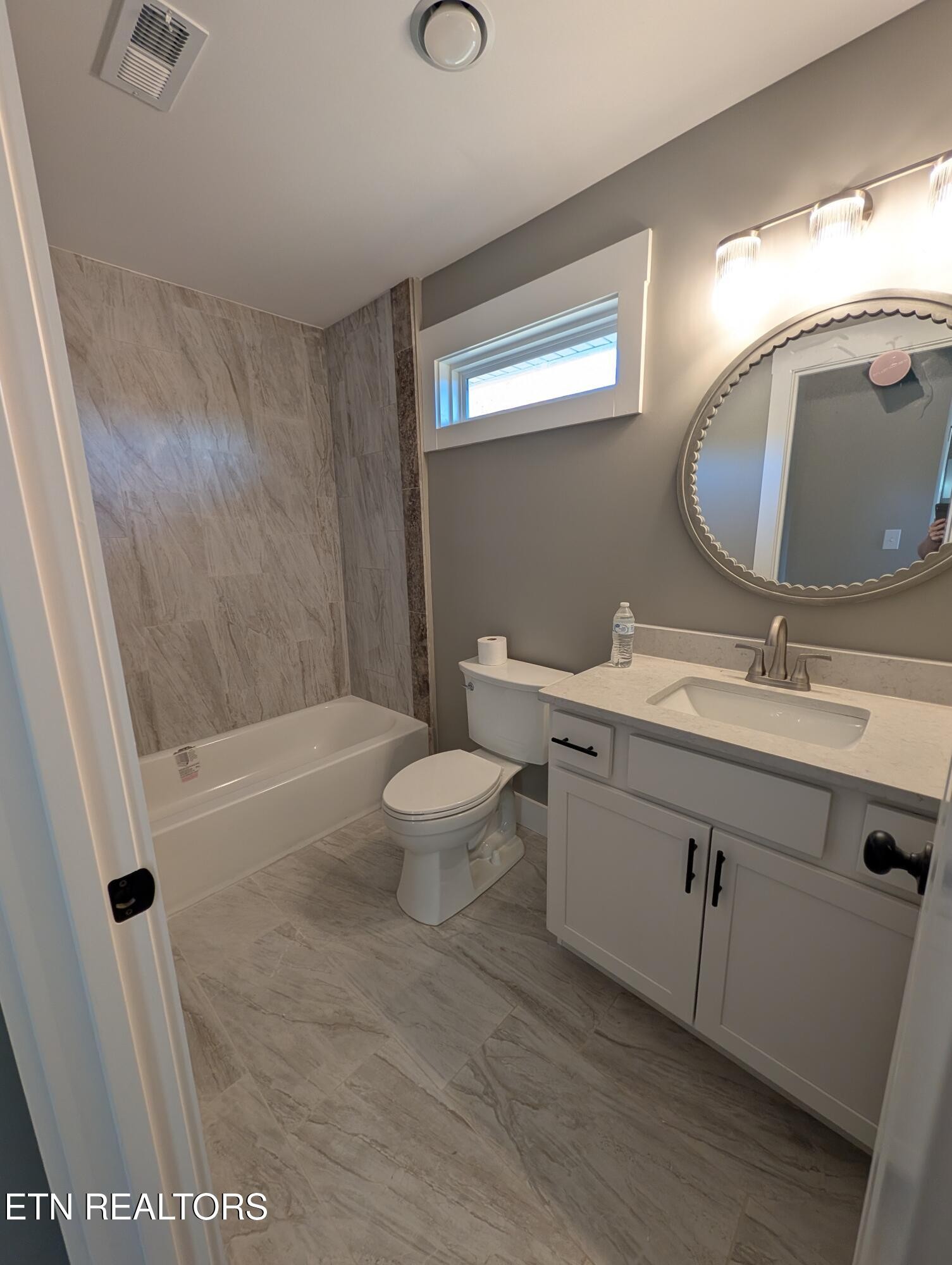 144 Abbott Road Lenoir City, TN 37771 - Photo 18 of 24 a bathroom with a double vanity sink toilet and shower