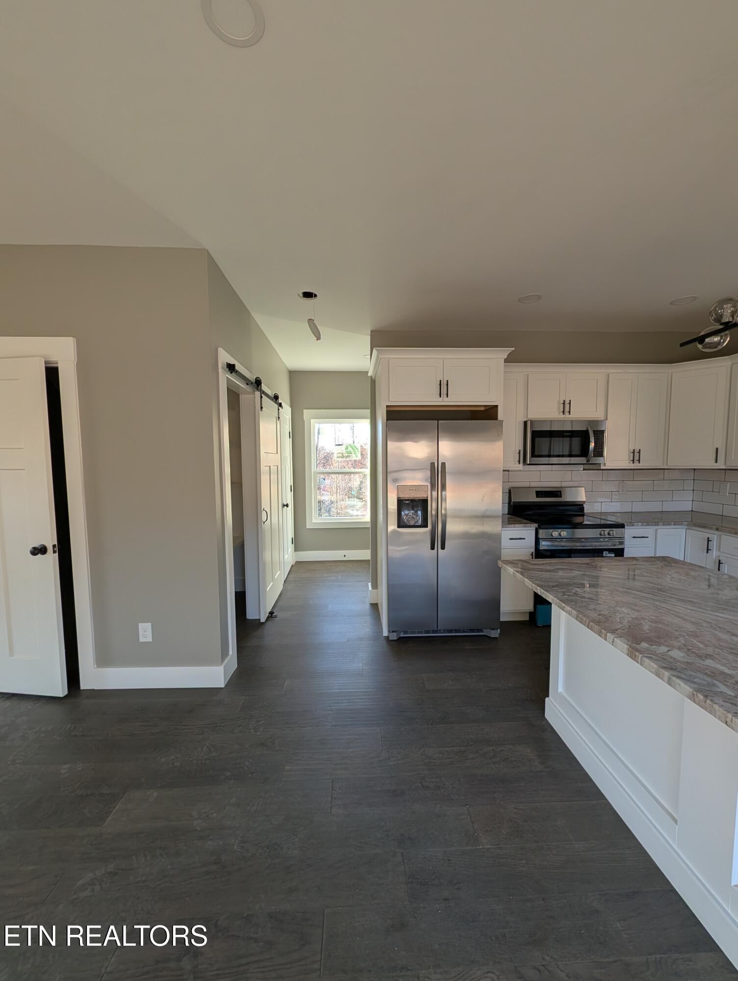 144 Abbott Road Lenoir City, TN 37771 - Photo 5 of 24 a kitchen with stainless steel appliances granite countertop a refrigerator sink and stove