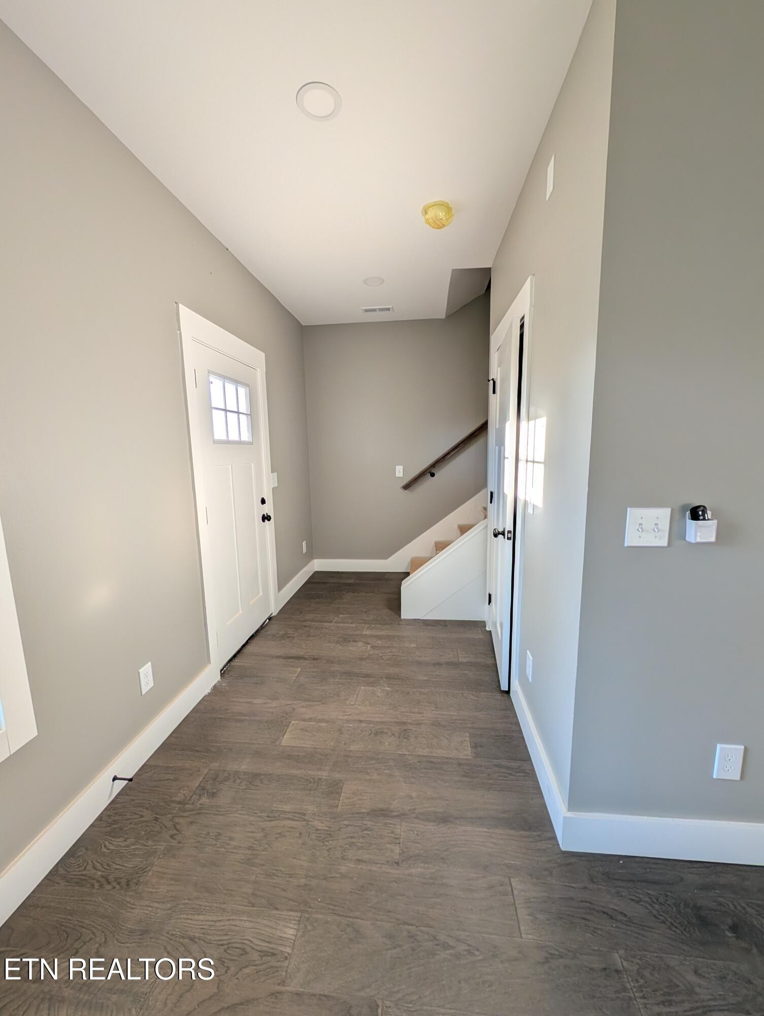 144 Abbott Road Lenoir City, TN 37771 - Photo 10 of 24 an empty room with staircase and white walls