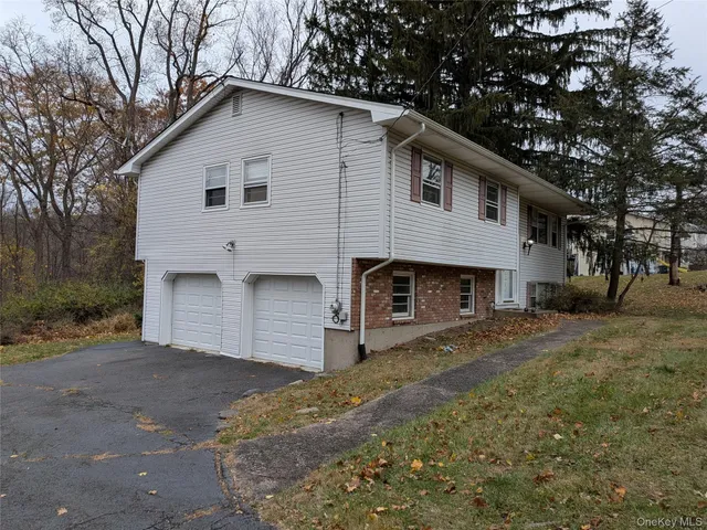 a view of a house with a yard and sitting area