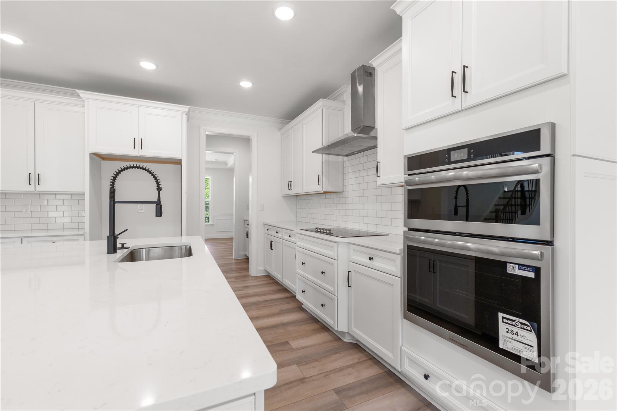 5944 Bakers Point Hickory, NC 28602 - Photo 15 of 39 a large white kitchen with stainless steel appliances granite countertop a stove a sink and a refrigerator