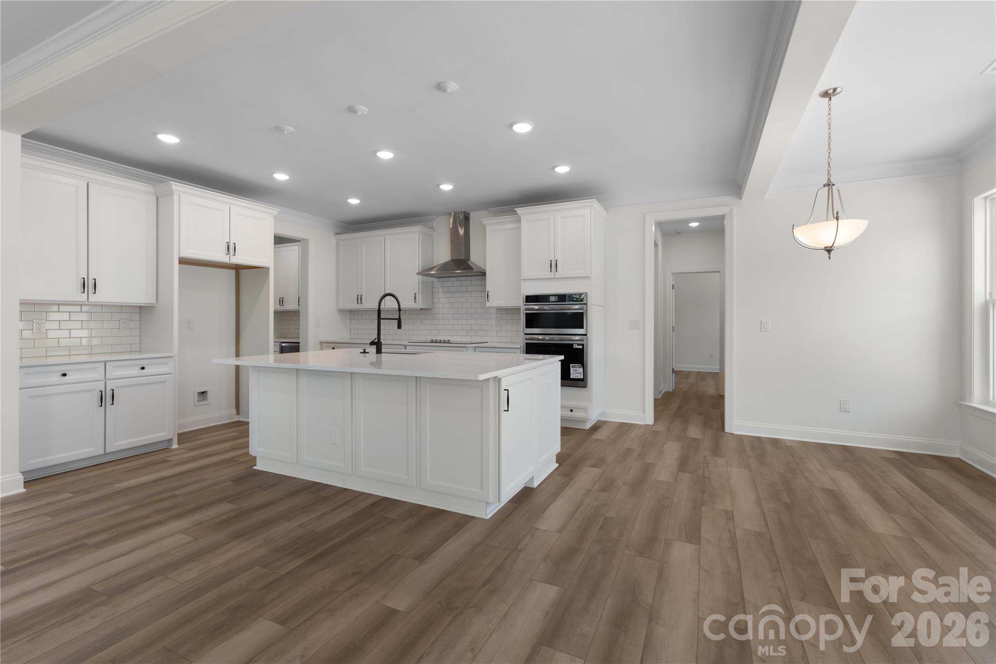 5944 Bakers Point Hickory, NC 28602 - Photo 17 of 39 a large kitchen with kitchen island a sink a center island stainless steel appliances and a counter space