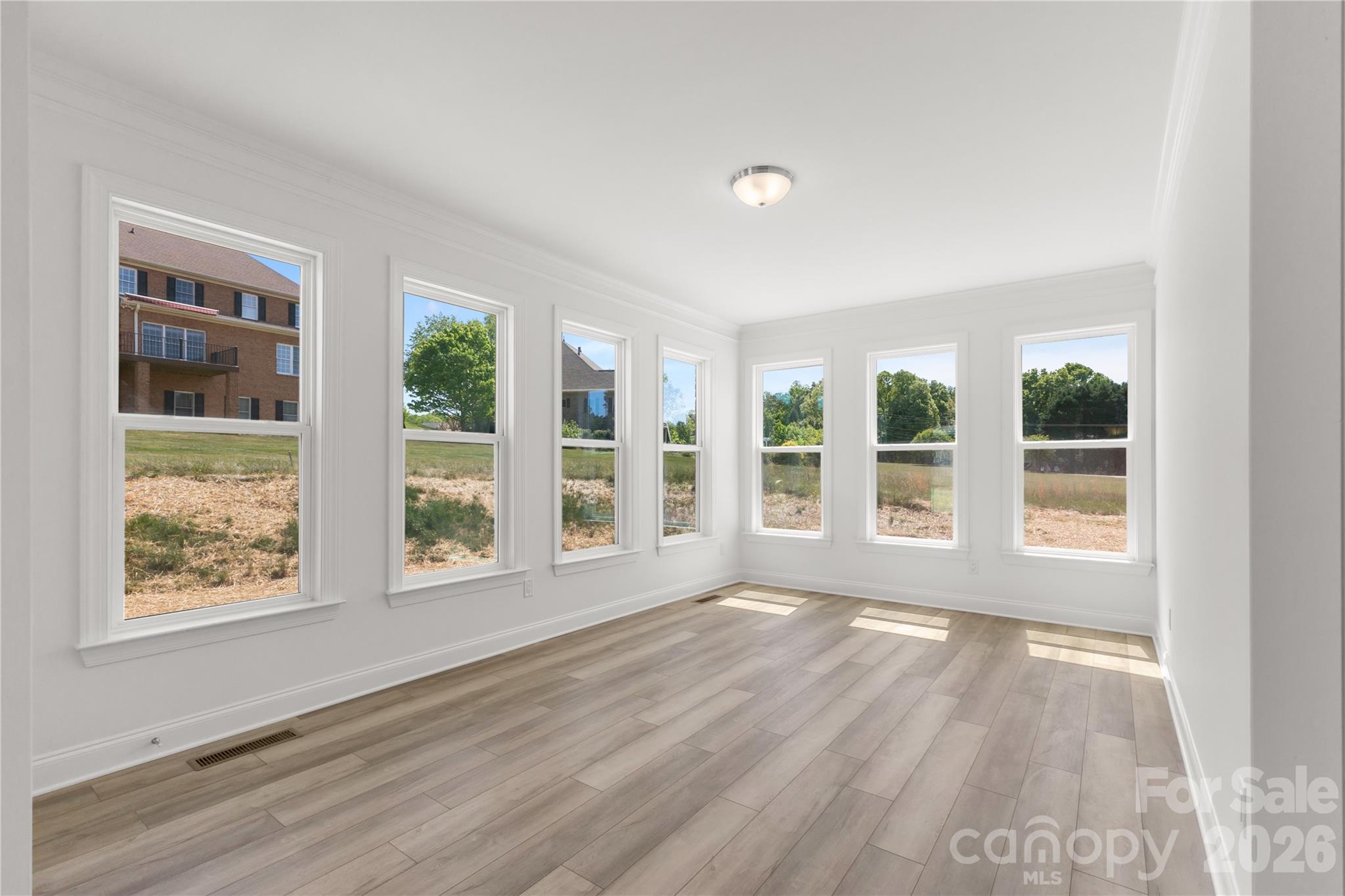 5944 Bakers Point Hickory, NC 28602 - Photo 23 of 39 a view of an empty room with a window and wooden floor