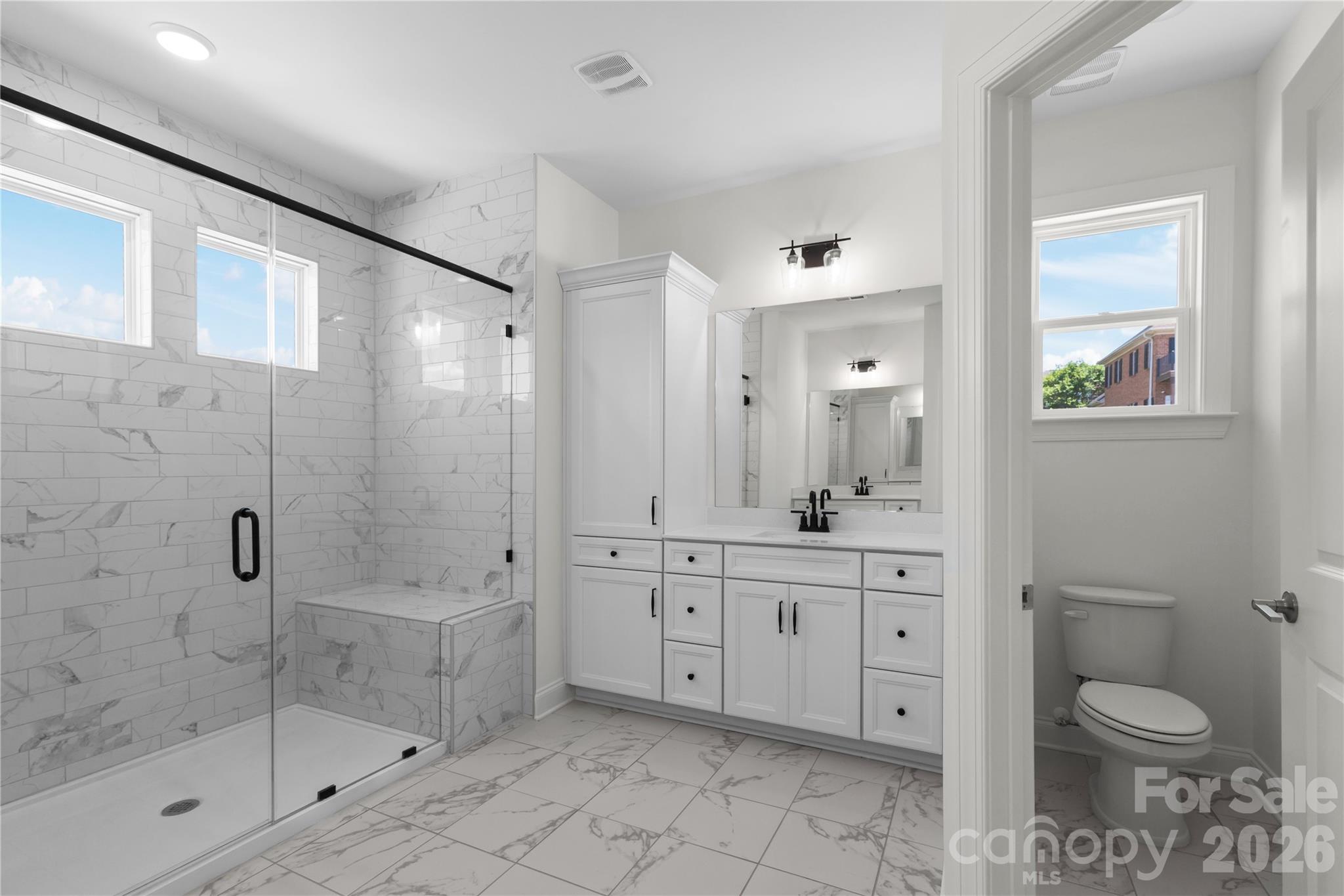 5944 Bakers Point Hickory, NC 28602 - Photo 33 of 39 a spacious bathroom with a shower sink mirror and toilet