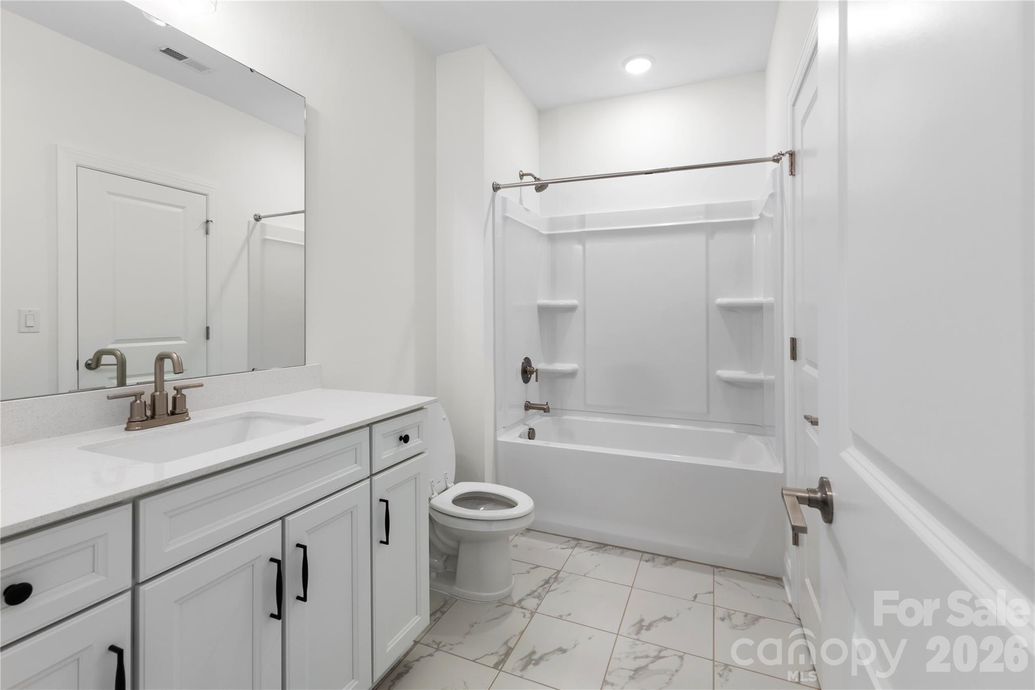 5944 Bakers Point Hickory, NC 28602 - Photo 36 of 39 a bathroom with a granite countertop sink a toilet and shower