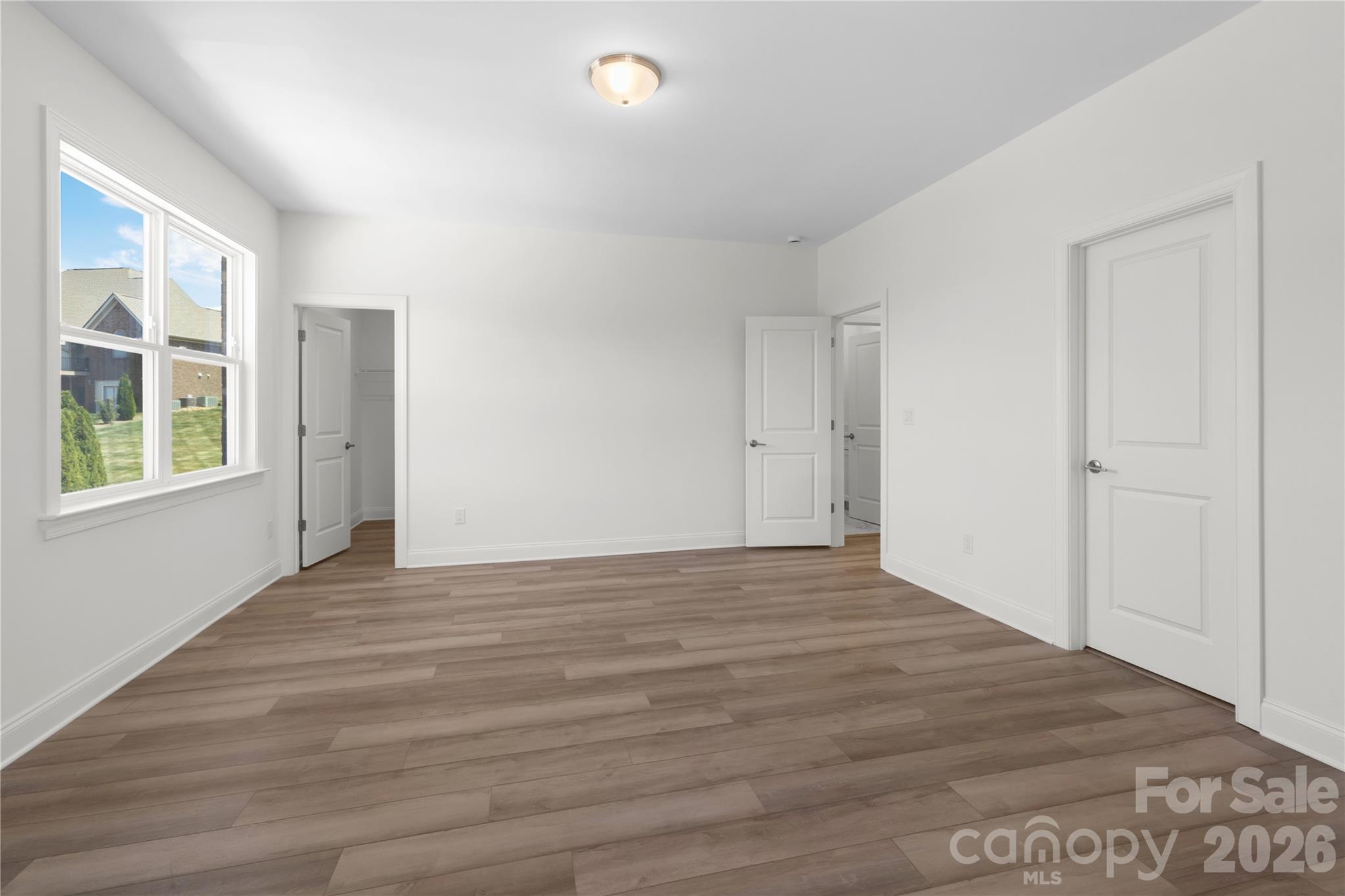 5944 Bakers Point Hickory, NC 28602 - Photo 37 of 39 a view of an empty room with wooden floor and windows