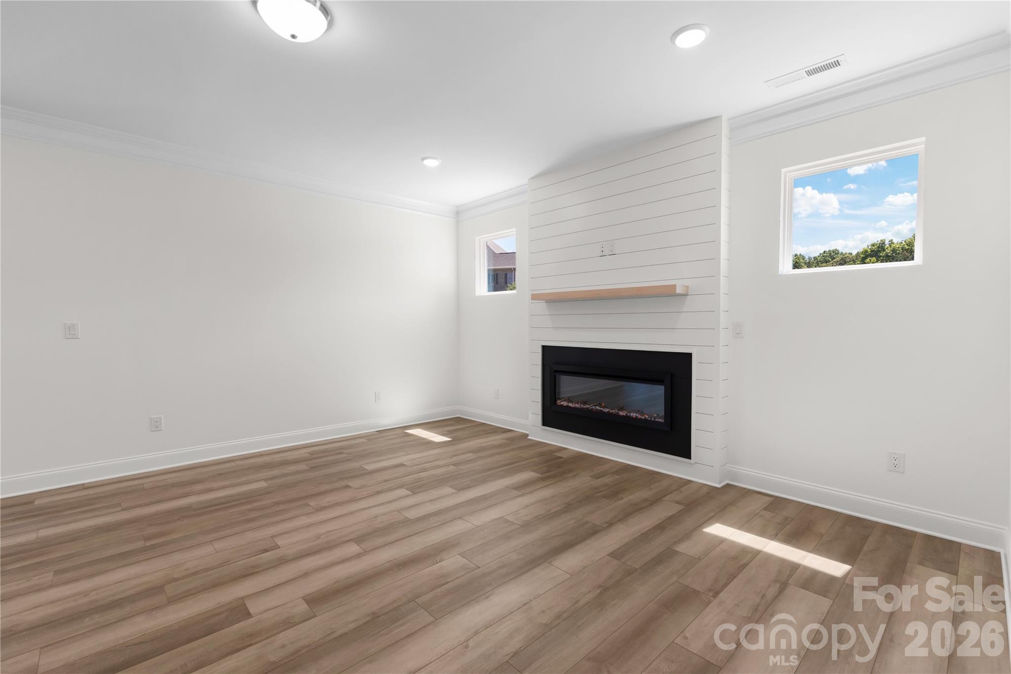 5944 Bakers Point Hickory, NC 28602 - Photo 8 of 39 a view of empty room with wooden floor and fireplace