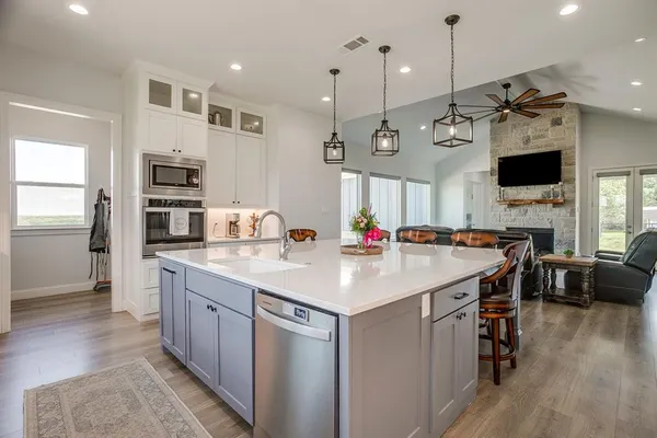 a kitchen with kitchen island a sink counter top space stainless steel appliances and a center island