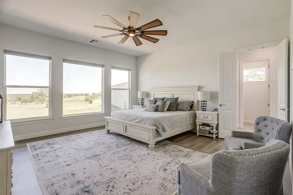 a bedroom with a bed couch and window
