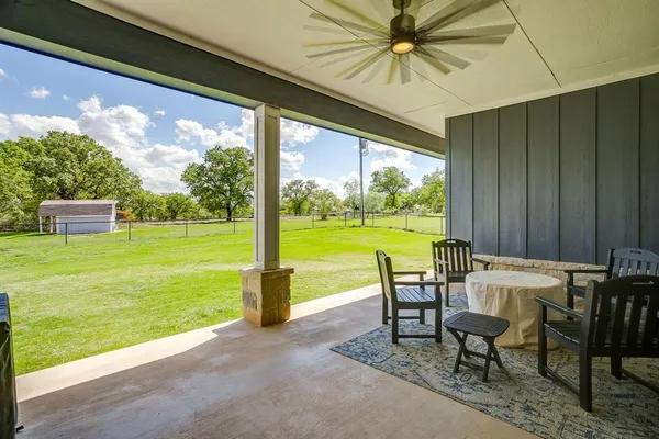 a view of a patio with a table chairs and a table