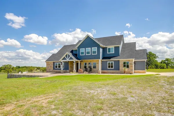 a big house with a big yard and large trees