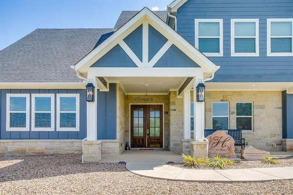 a front view of a house with outdoor seating