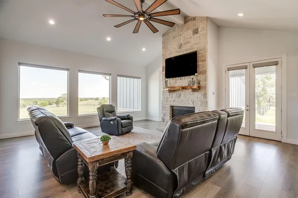 a living room with fireplace furniture and a flat screen tv
