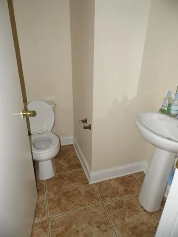 a white toilet sitting next to a sink
