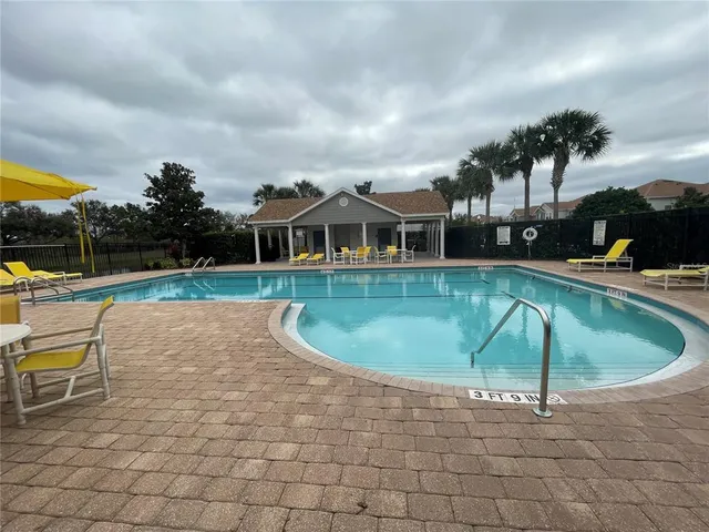 a swimming pool with outdoor seating and yard