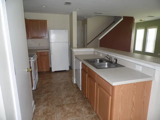 a kitchen that has a sink and a stove in it