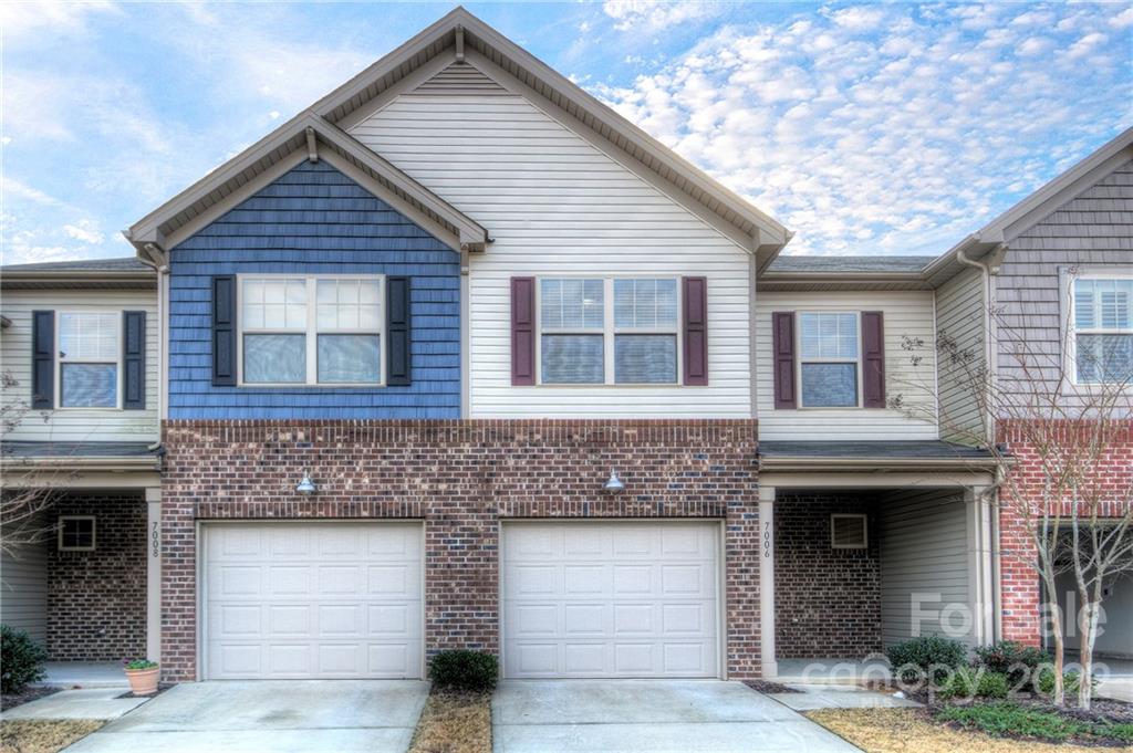a front view of a house with garage