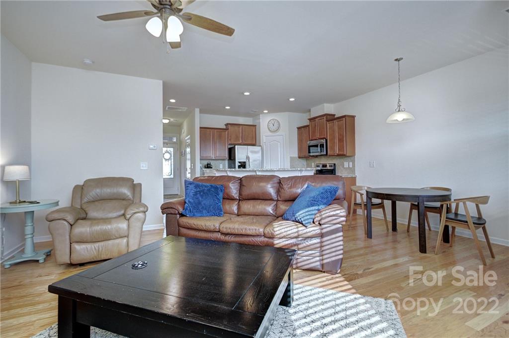7006 Swamp Chestnut Lane Indian Land, SC 29707 - Photo 11 of 25 a living room with kitchen island furniture and a chandelier
