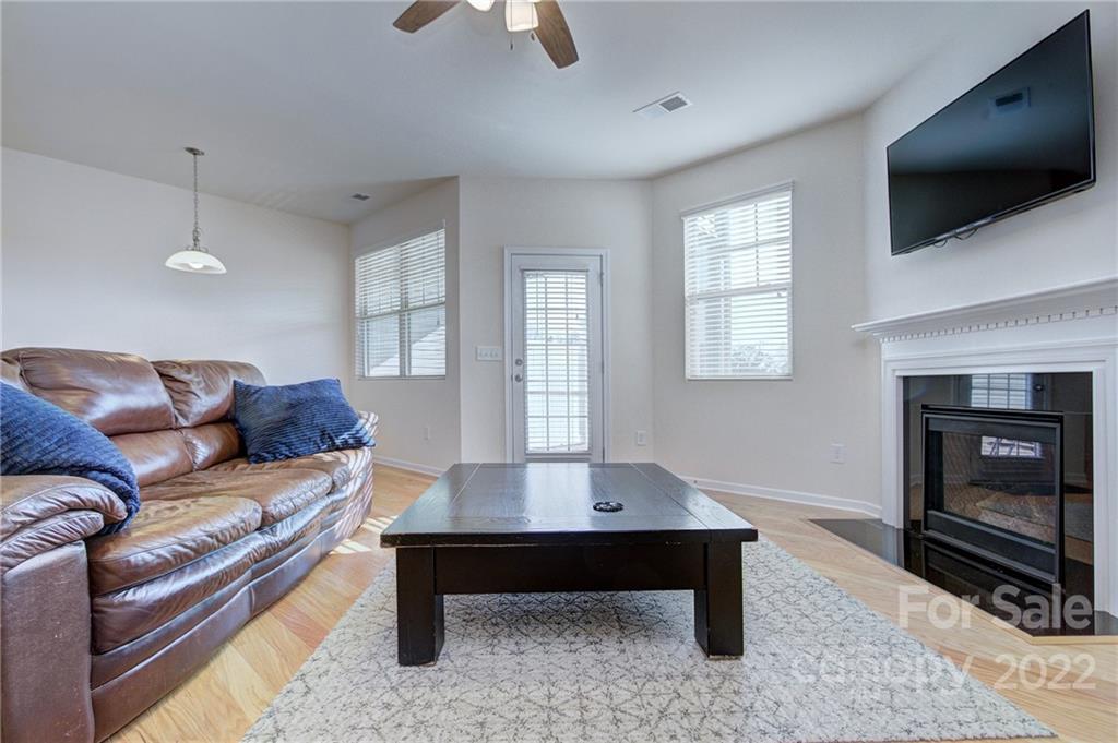 7006 Swamp Chestnut Lane Indian Land, SC 29707 - Photo 12 of 25 a living room with furniture a flat screen tv and a fireplace