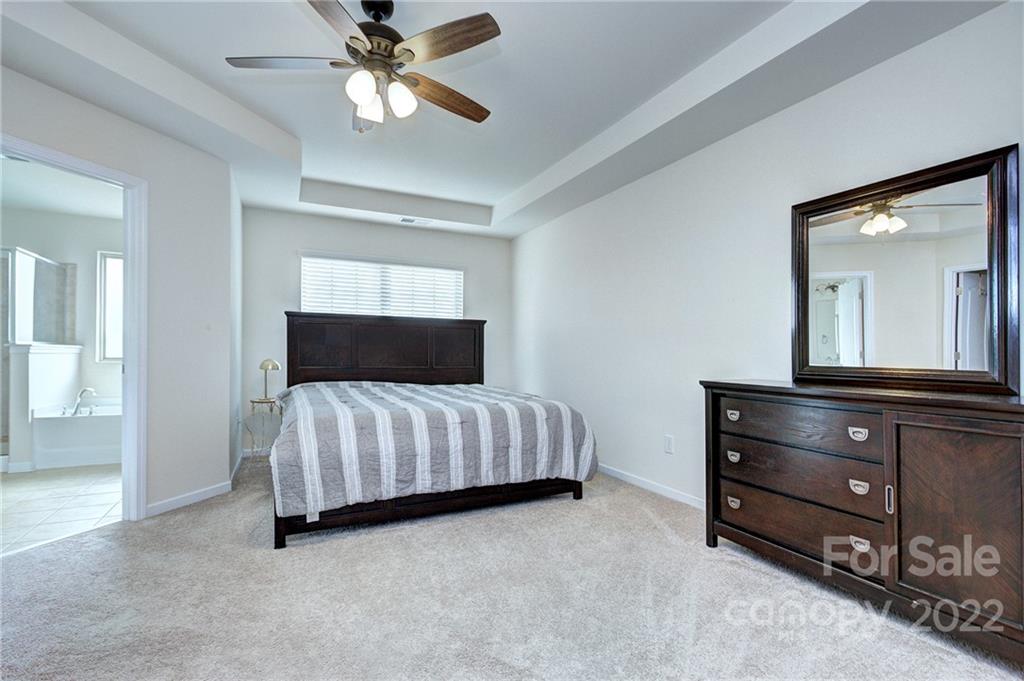 7006 Swamp Chestnut Lane Indian Land, SC 29707 - Photo 14 of 25 a bedroom with a bed and a dresser