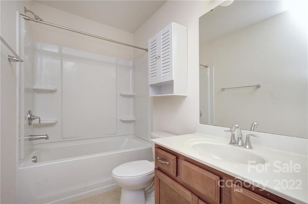 7006 Swamp Chestnut Lane Indian Land, SC 29707 - Photo 21 of 25 a bathroom with a granite countertop sink toilet and bathtub