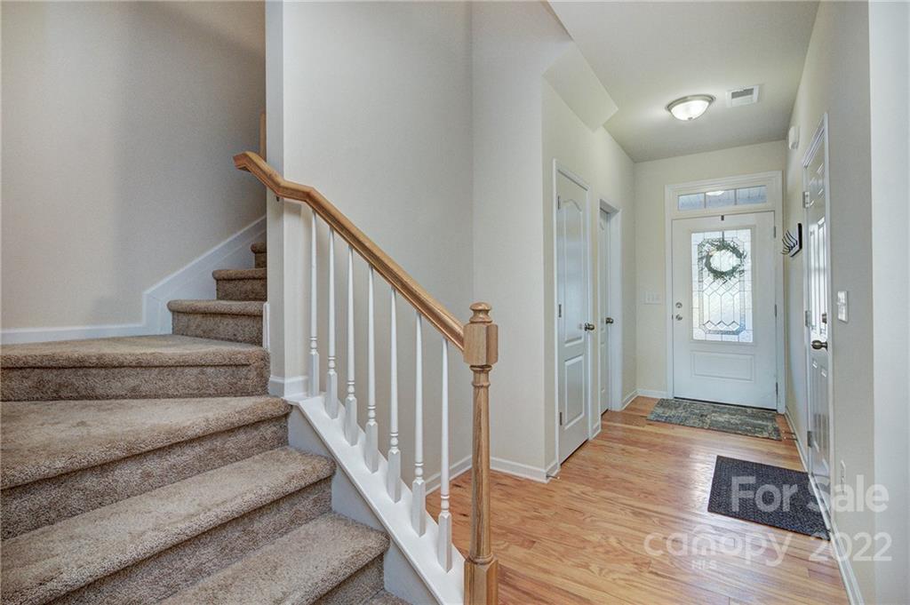 7006 Swamp Chestnut Lane Indian Land, SC 29707 - Photo 3 of 25 a view of a hallway with wooden floor and staircase