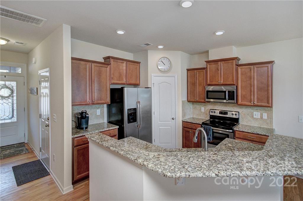 7006 Swamp Chestnut Lane Indian Land, SC 29707 - Photo 4 of 25 a kitchen with stainless steel appliances granite countertop a refrigerator oven a sink and dishwasher