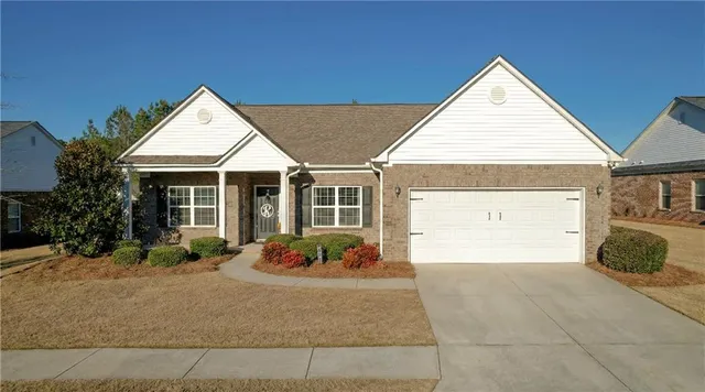a front view of a house with garden