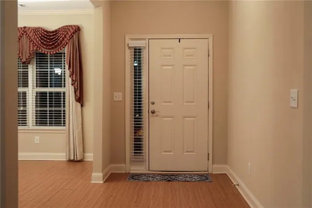 an empty room with wooden floor and a window