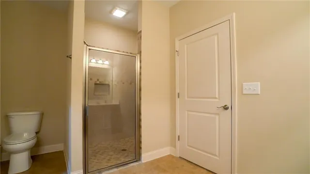 a bathroom that has a glass shower door