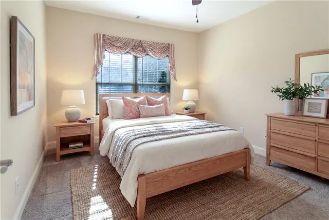 a bedroom with a bed and a window